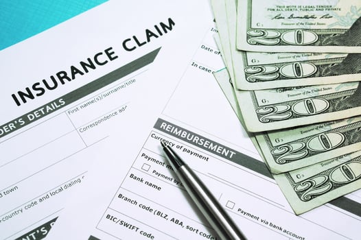 Claims management systems: insurance claim forms, a pen and cash