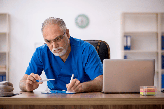 HR compliance: doctor writing on a piece of paper while holding a thermometer