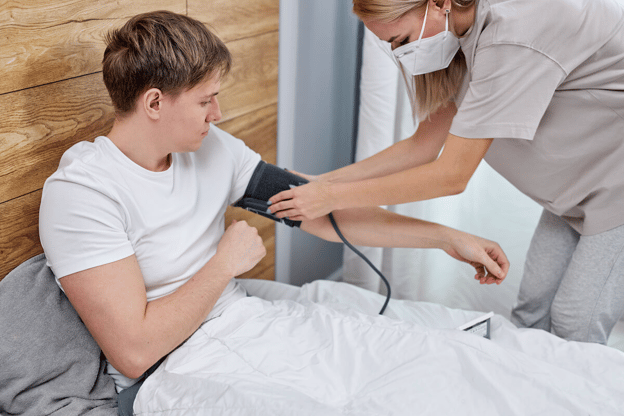 Leave of absence request: nurse checking a patient's blood pressure