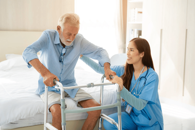 Nurse helping an elderly patient stand-up