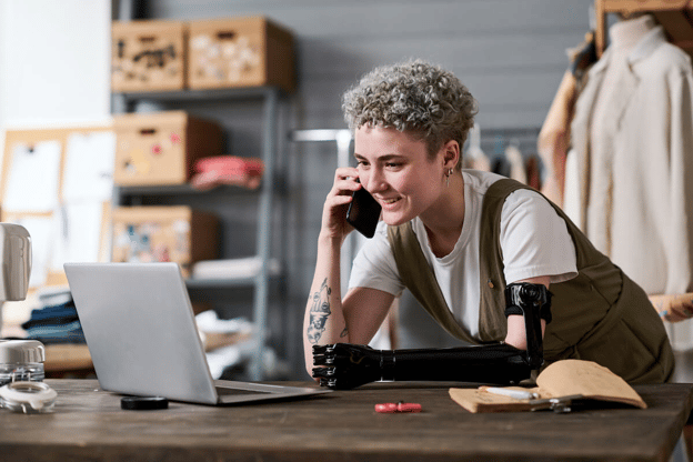 Entrepreneur with a prosthetic arm talking on the phone