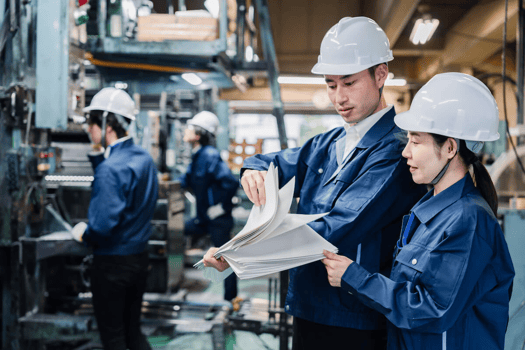 Risk management benefits: factory employees looking at some documents
