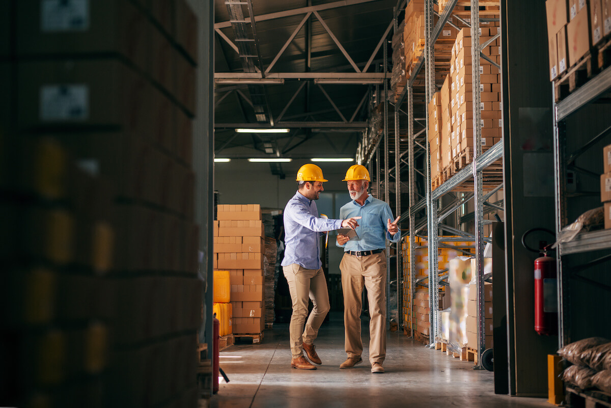 GRC tools: 2 engineers walking inside a warehouse